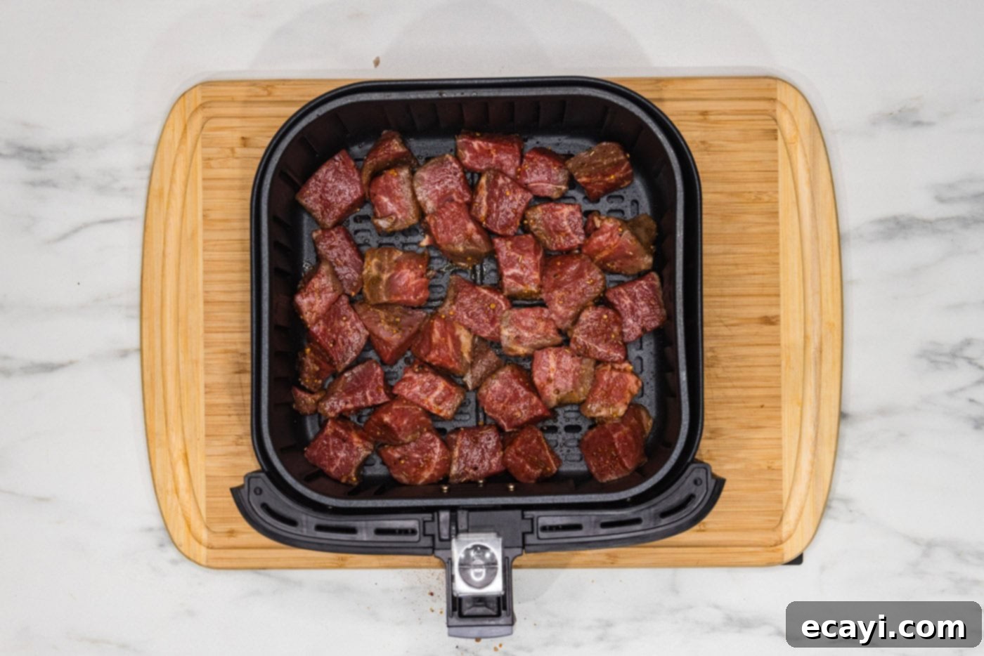 Ultimate Air Fryer Steak Bites 6 steak bites in an air fryer basket