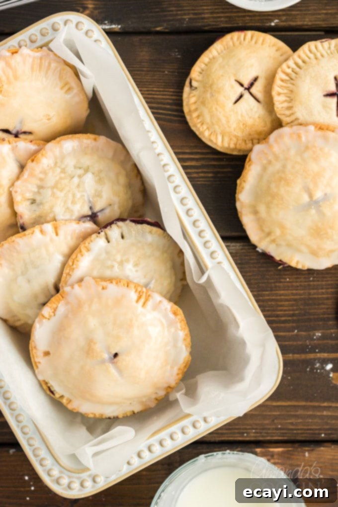 Making blueberry hand pies is fun and easy, and using a refrigerator pie crust dough cuts down on the work. Mini blueberry pies are delicious! dish full of blueberry hand pies