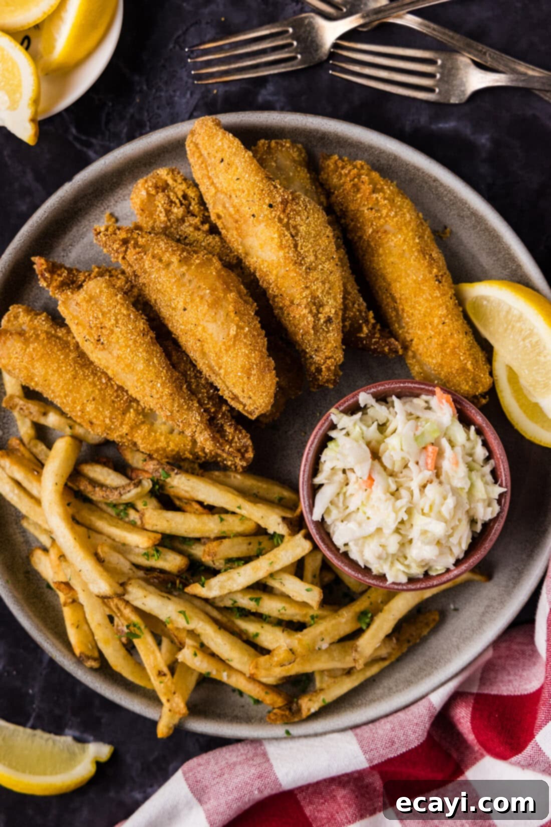 Golden Crispy Perch 2 Close up photo of Fried Perch on a plate with fries, coleslaw and lemon wedges on the side