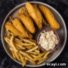 Golden Crispy Perch 9 Fried Perch on a plate with fries and coleslaw