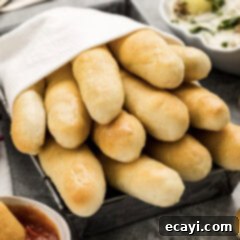 Endless Warm Garlic Breadsticks 16 Soft Olive Garden Breadsticks wrapped in a towel, showcasing their perfect texture.