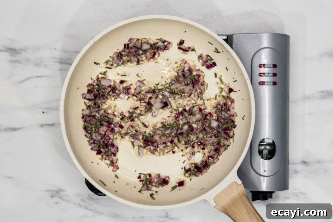 Crafted Lamb Burgers 5 Onion, garlic, and rosemary gently sauteeing in a skillet, releasing their fragrant aromas