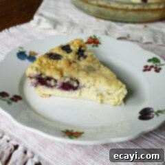 Blackberry Coconut Magic Pie 10 A slice of blackberry coconut impossible pie on a plate.