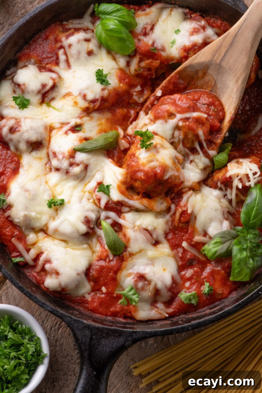 Cheesy Chicken Parm Bites 2 Close up photo of a spoon in a skillet of Chicken Parmesan Meatballs