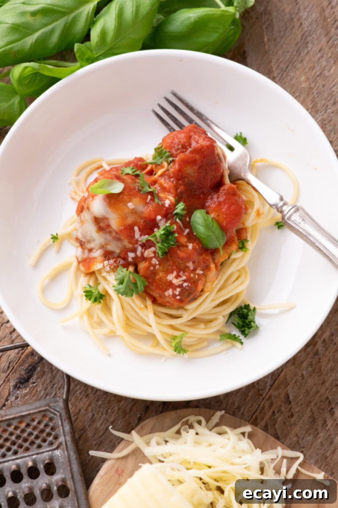 Cheesy Chicken Parm Bites 11 Chicken Parmesan Meatballs plated over spaghetti