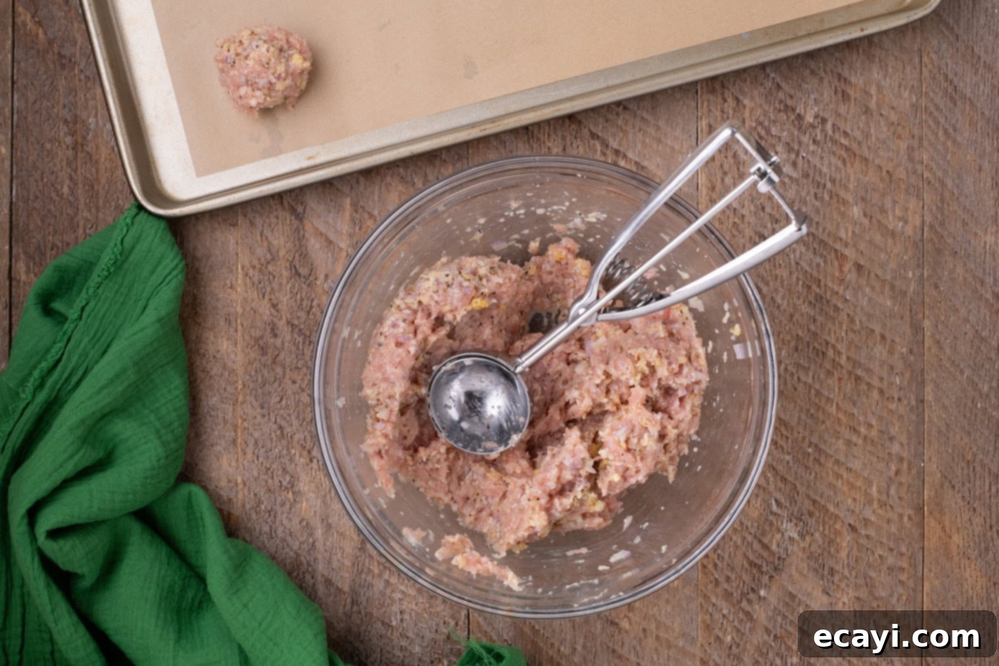 Cheesy Chicken Parm Bites 6 chicken meatball mixture in a bowl with a scoop