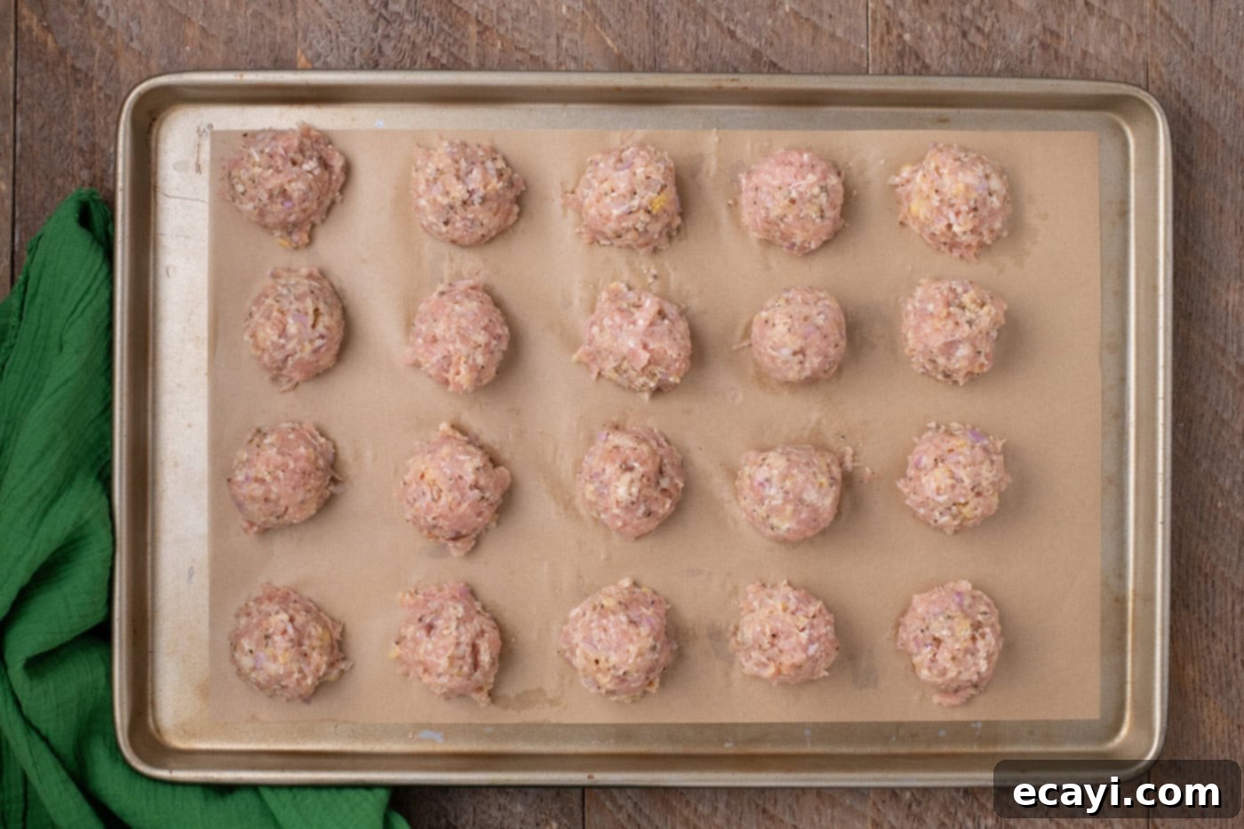 Cheesy Chicken Parm Bites 7 chicken meatballs on parchment lined baking shet