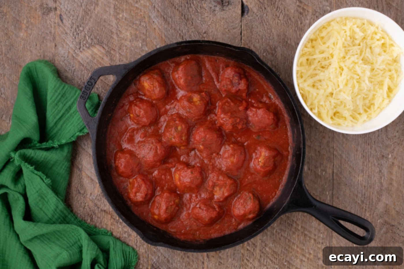 Cheesy Chicken Parm Bites 9 chicken meatballs in a skillet covered in marinara sauce