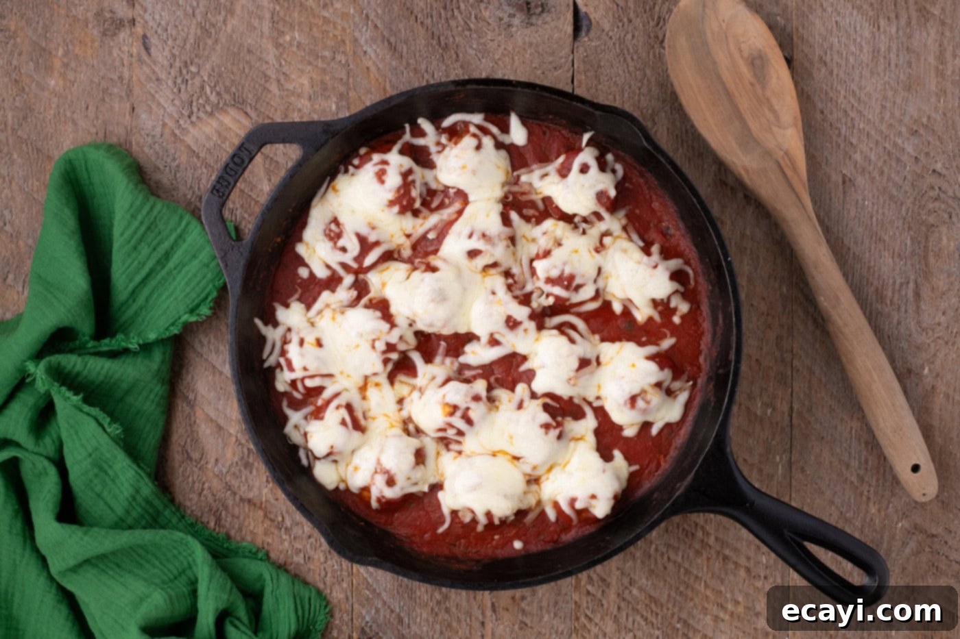 Cheesy Chicken Parm Bites 10 melted cheese over chicken parmesan meatballs in a skillet