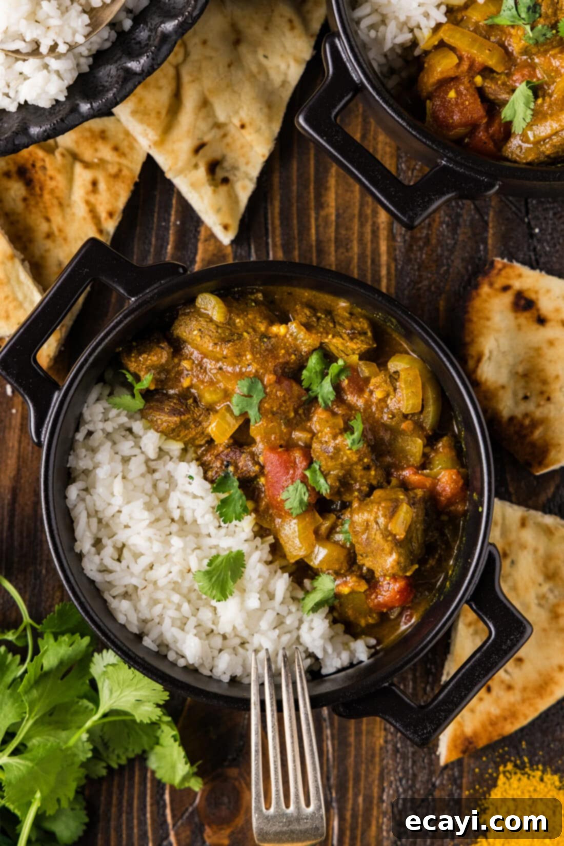 Tender Beef Curry 10 A beautifully presented bowl of Easy Stovetop Beef Curry with white rice, a fork resting on the side, ready to be enjoyed