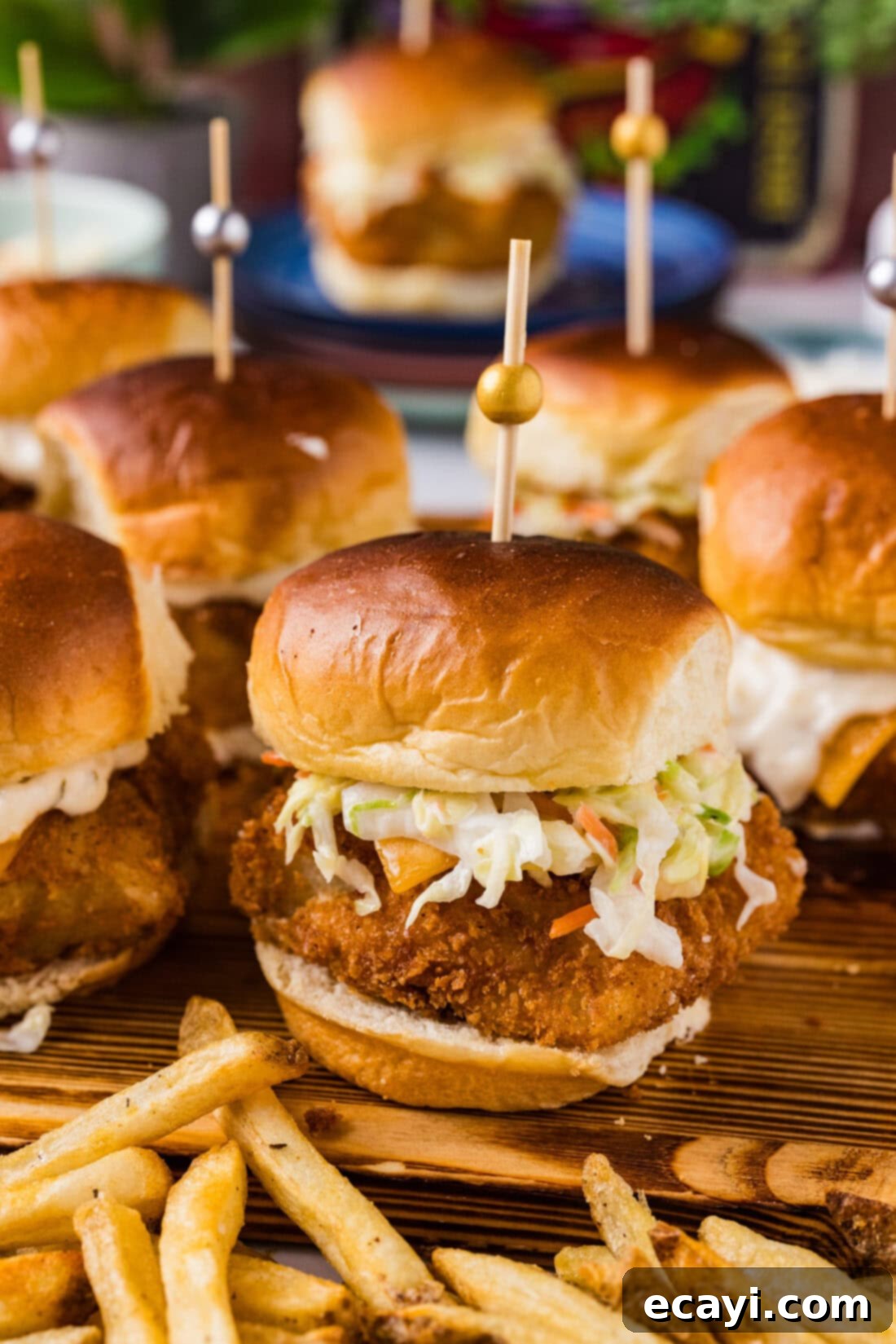 Crispy Fish Sliders 2 Close up photo of a Fish Slider on a wooden platter with french fries