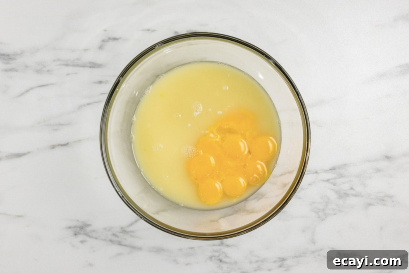 Tangy Key Lime Dessert Bars 7 egg yolks, lime juice, and sweetened condensed milk in a bowl