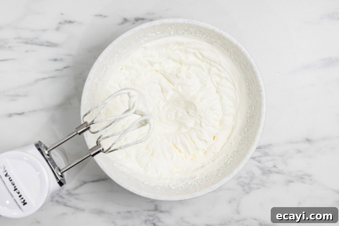 Tangy Key Lime Dessert Bars 10 whipped cream in a bowl with electric mixer