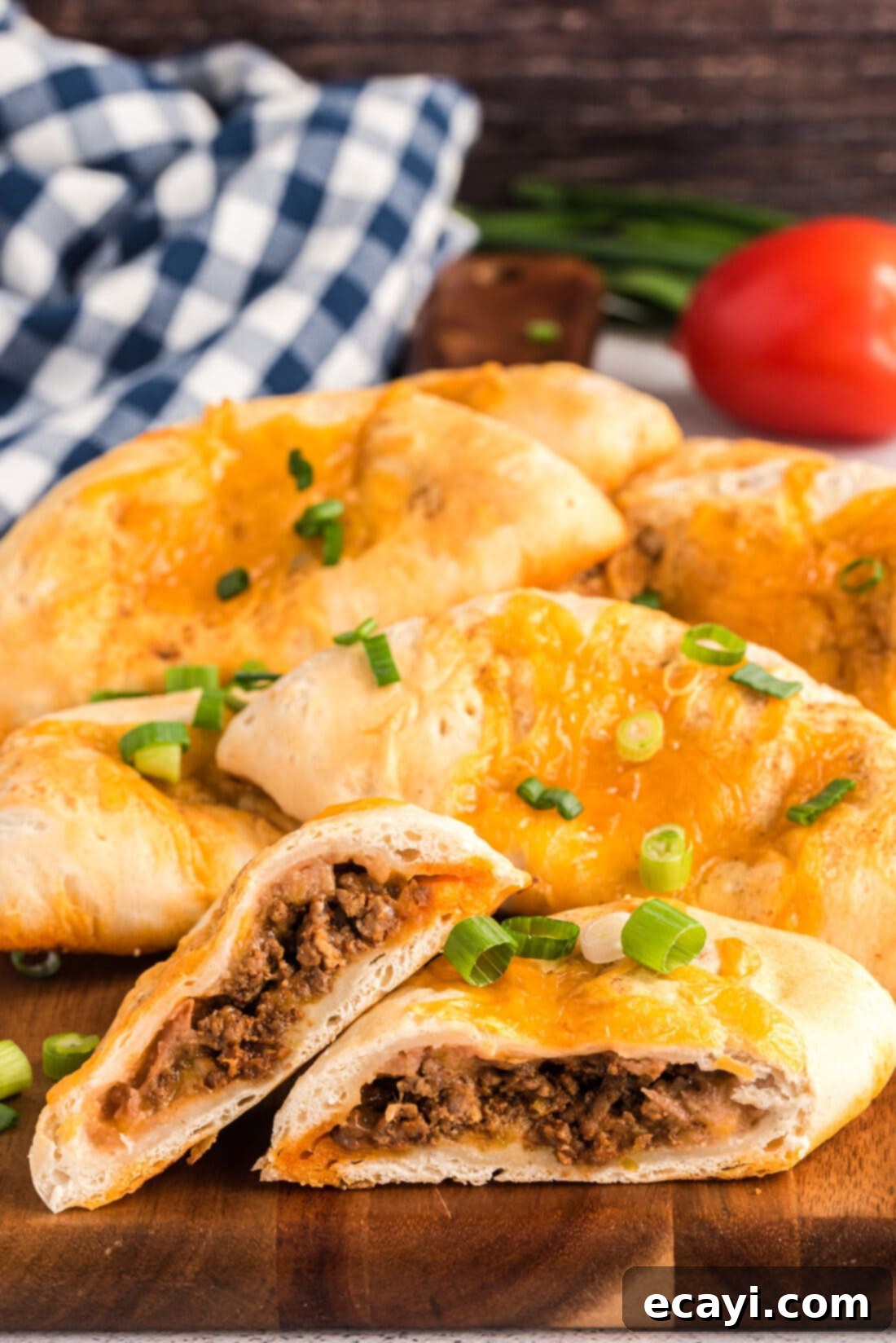 Crispy Taco Turnovers 2 Taco Empanadas cut in half, revealing cheesy, meaty filling