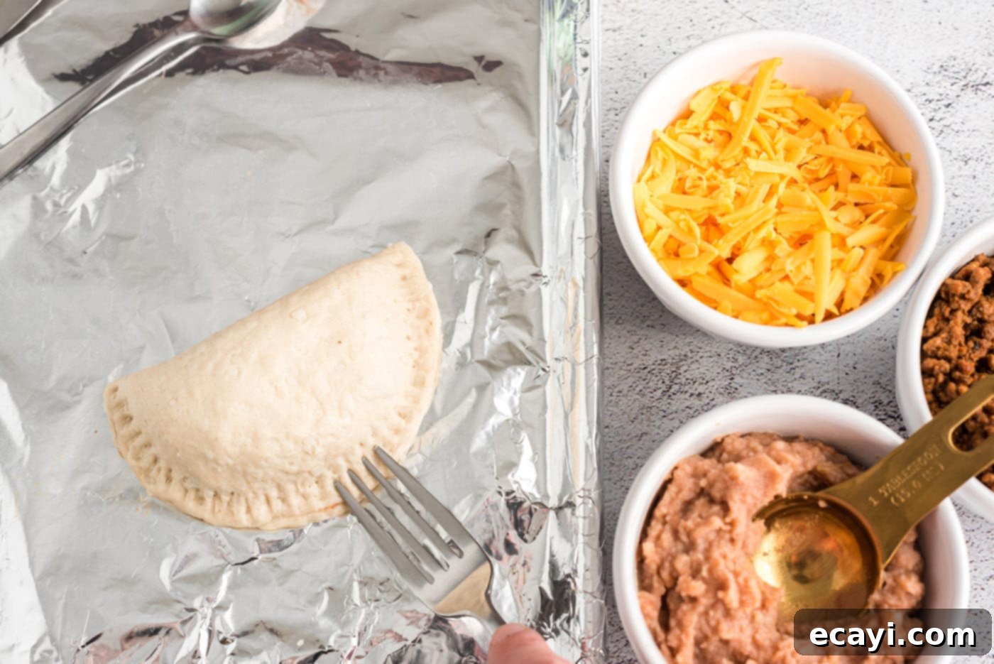 Crispy Taco Turnovers 10 sealing empanadas with a fork