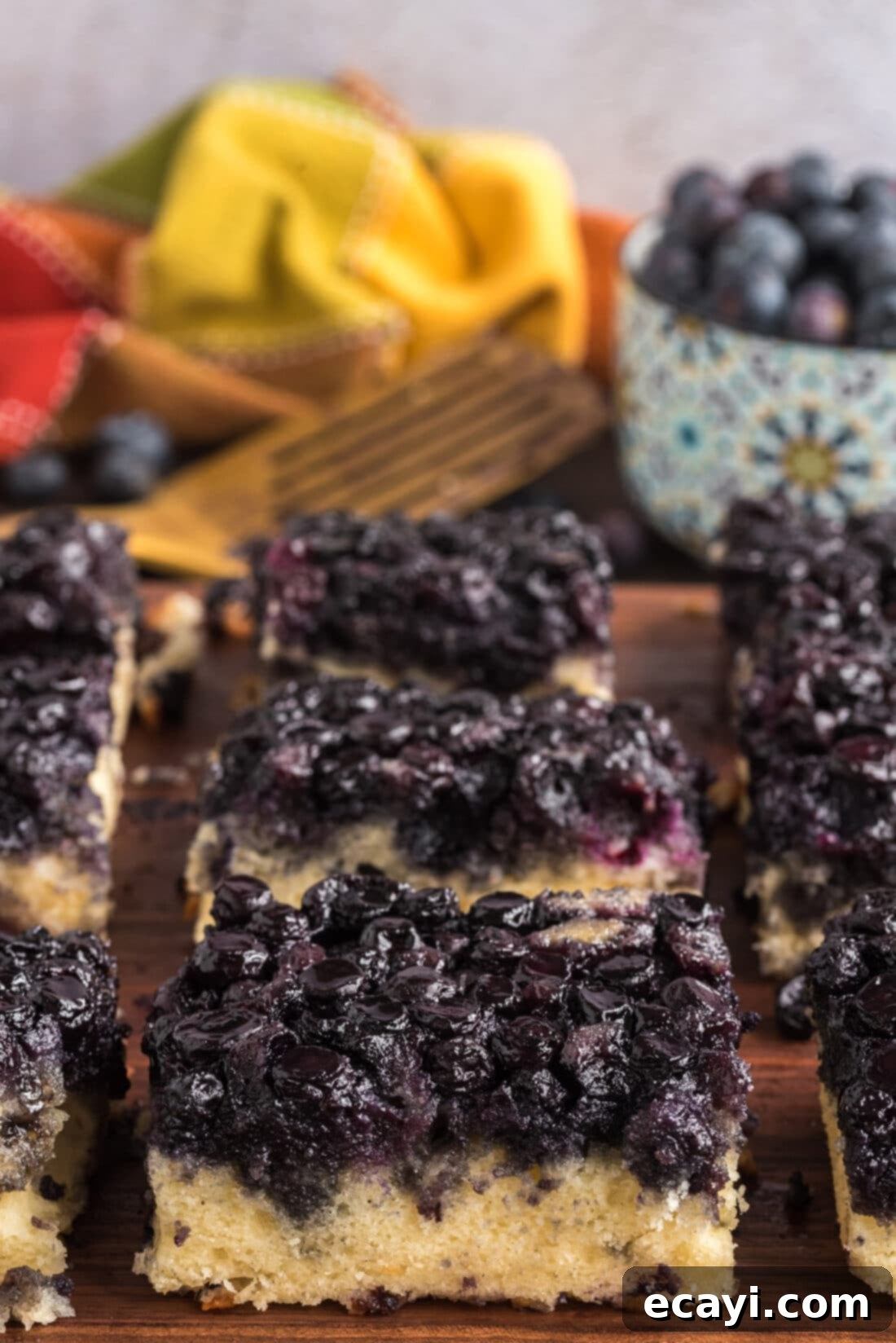 Blueberry Flip Cake 2 Easy Blueberry Upside Down Cake cut into squares on a wooden board