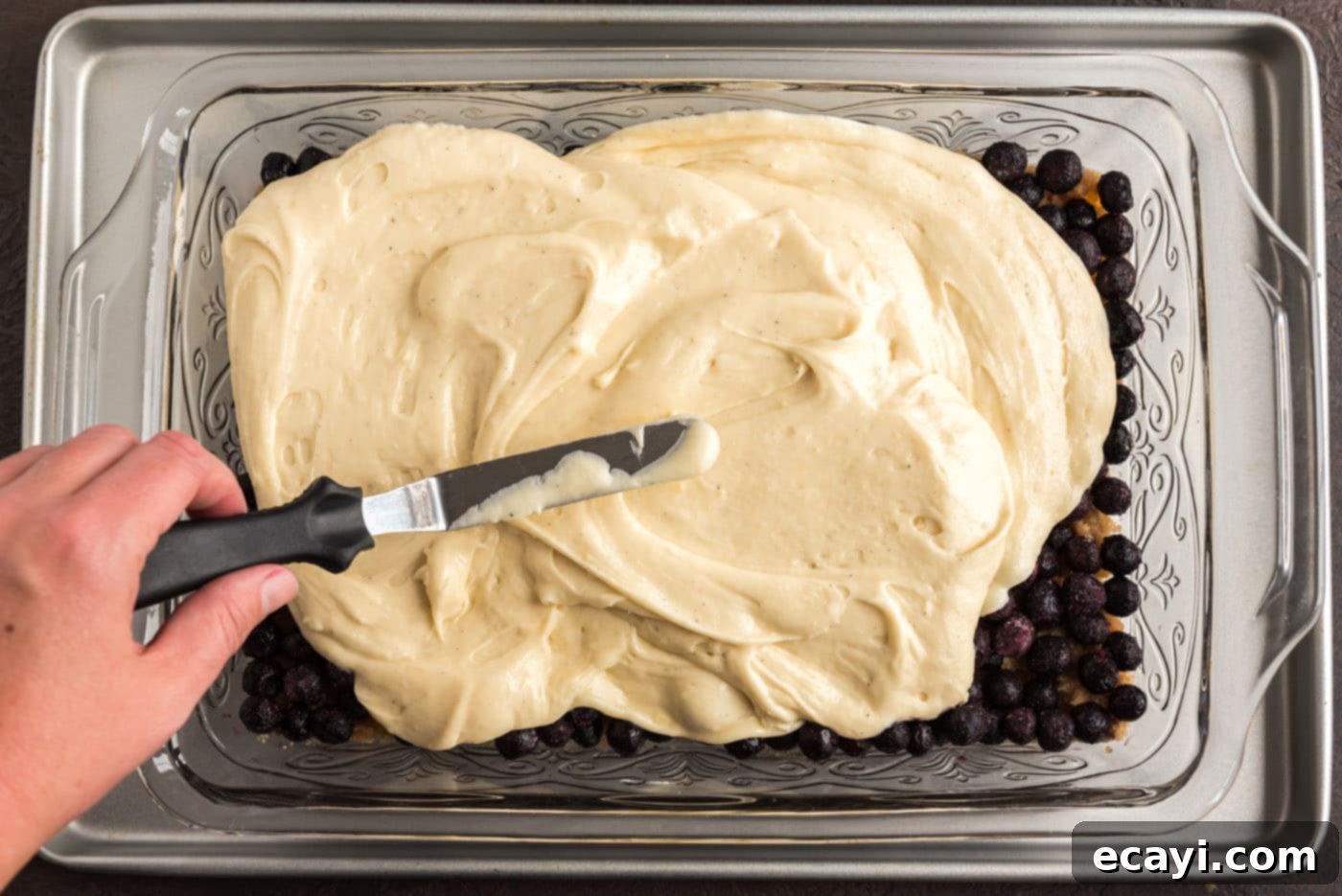 Blueberry Flip Cake 11 spreading cake batter over blueberries and brown sugar mixture