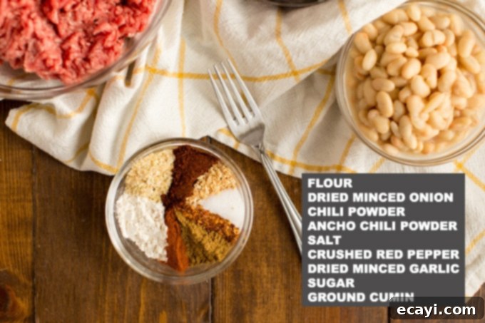 This 3 Bean Chili is made with a homemade chili seasoning, fresh ground beef, fire roasted tomatoes, and three types of canned beans. Great for football!  A collection of spices and dried herbs laid out, representing the ingredients for homemade chili seasoning.