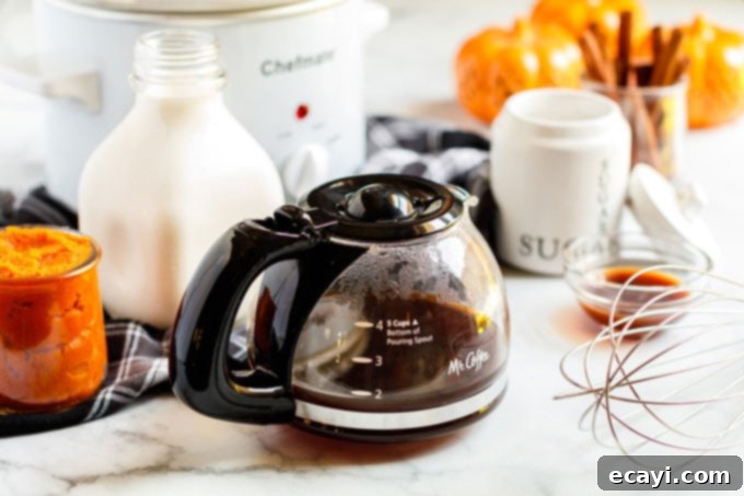Autumn Spice Dream 4 Slow cooker filled with pumpkin spice latte ingredients before cooking