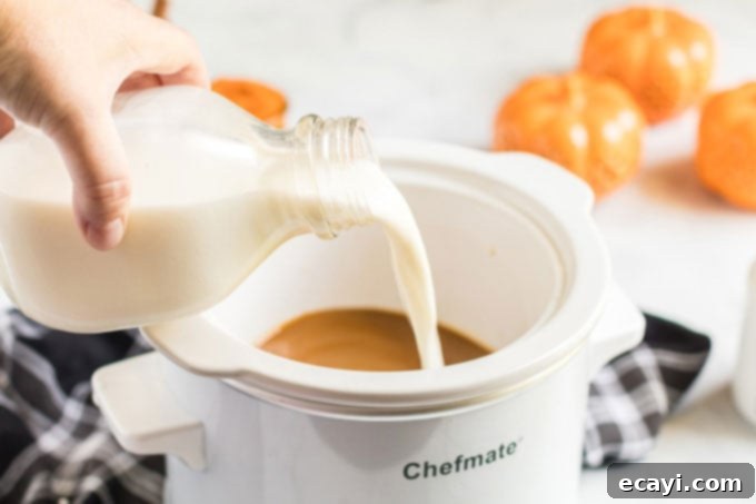 Autumn Spice Dream 5 Pouring milk into a small slow cooker, a key step for the pumpkin spice latte