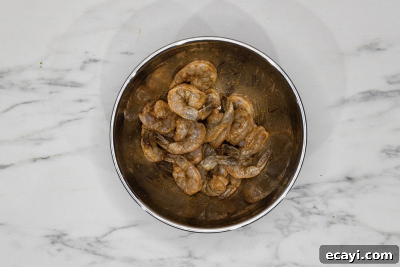 Zesty Lemon Broiled Shrimp 5 raw shrimp in a bowl tossed with oil and seasonings