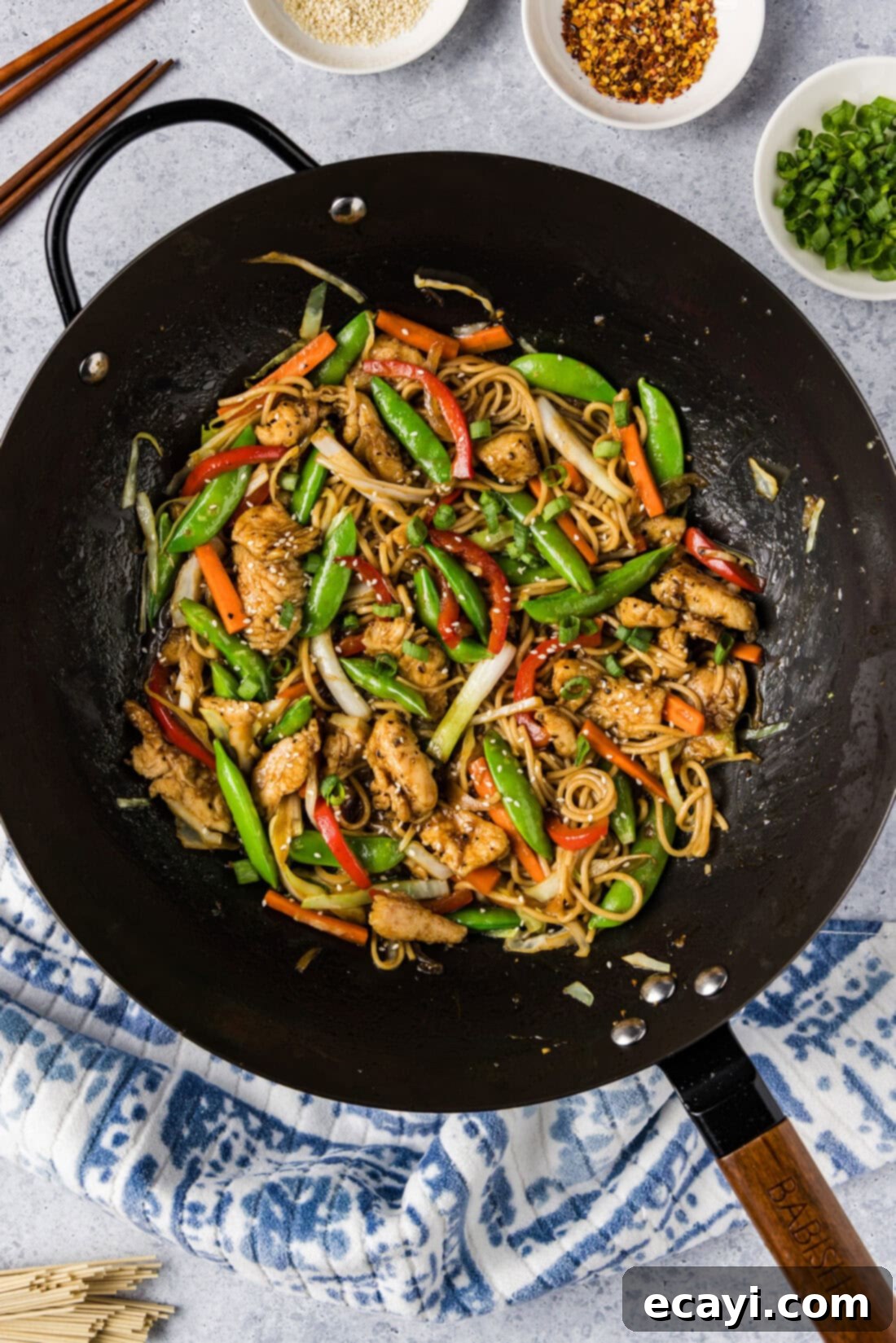 Classic Chicken Lo Mein 3 Close-up shot of Chicken Lo Mein in a large wok, showcasing the vibrant vegetables, chicken pieces, and glossy noodles coated in sauce.