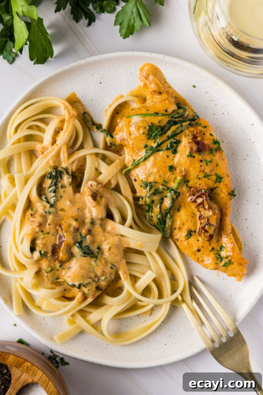 Sun-Kissed Tuscan Chicken 12 Tuscan Chicken served on a plate with pasta, showcasing the rich sauce and perfectly cooked chicken.