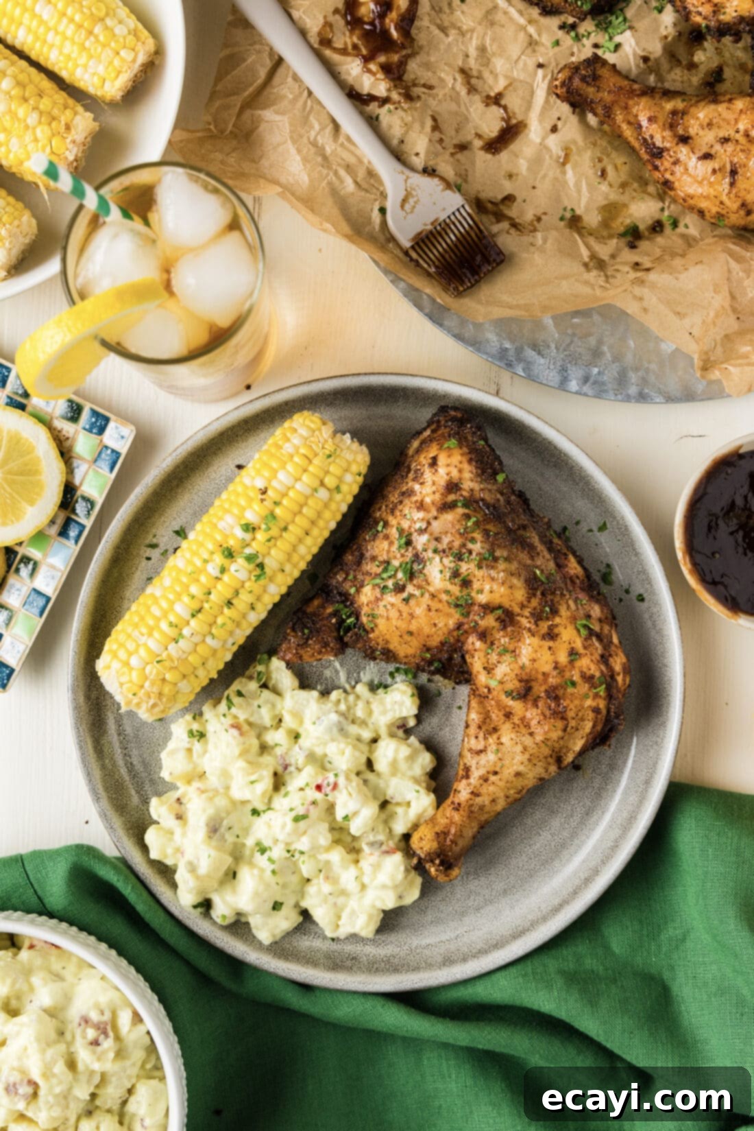 Juicy Smoked Chicken Quarters 7 Smoked Chicken Quarter on a plate with potato salad and corn on the cob