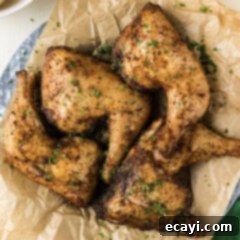 Juicy Smoked Chicken Quarters 8 Close up photo of Smoked Chicken Quarters on a parchment lined platter