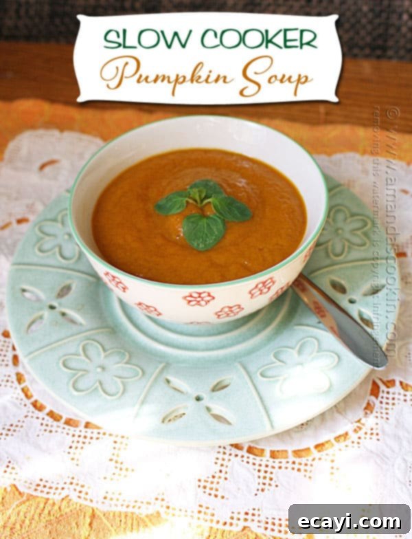 Cozy Slow Cooker Pumpkin Soup 3 A close up photo of a bowl of rich, orange slow cooker pumpkin soup, perfectly blended and ready to serve, with a spoon nearby, highlighting its smooth texture.