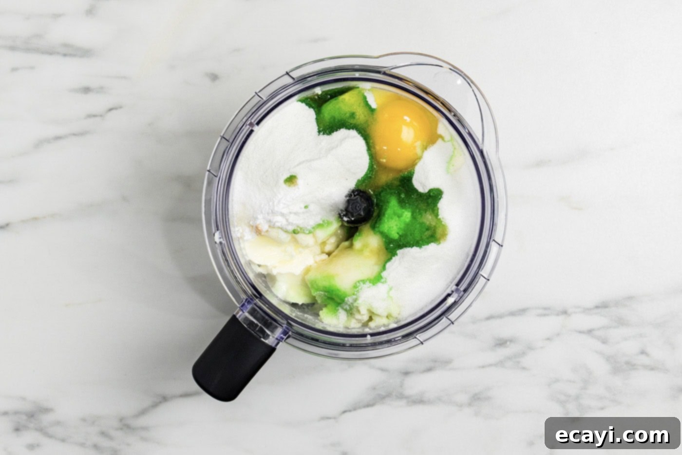 Tangy Keto Lime Cheesecake Minis 5 overhead photo of keto lime cheesecake ingredients in a food processor bowl