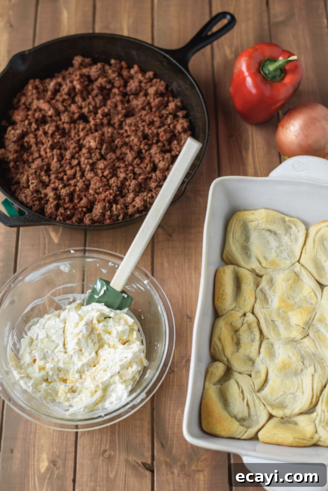 Ingredients for John Wayne Casserole: Fresh and ready for a delicious meal! Various ingredients for John Wayne Casserole laid out on a counter, including ground beef, biscuits, cheese, and fresh vegetables.