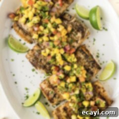 Succulent Grilled Mahi Mahi 11 Grilled Mahi Mahi on a white platter with lime wedges
