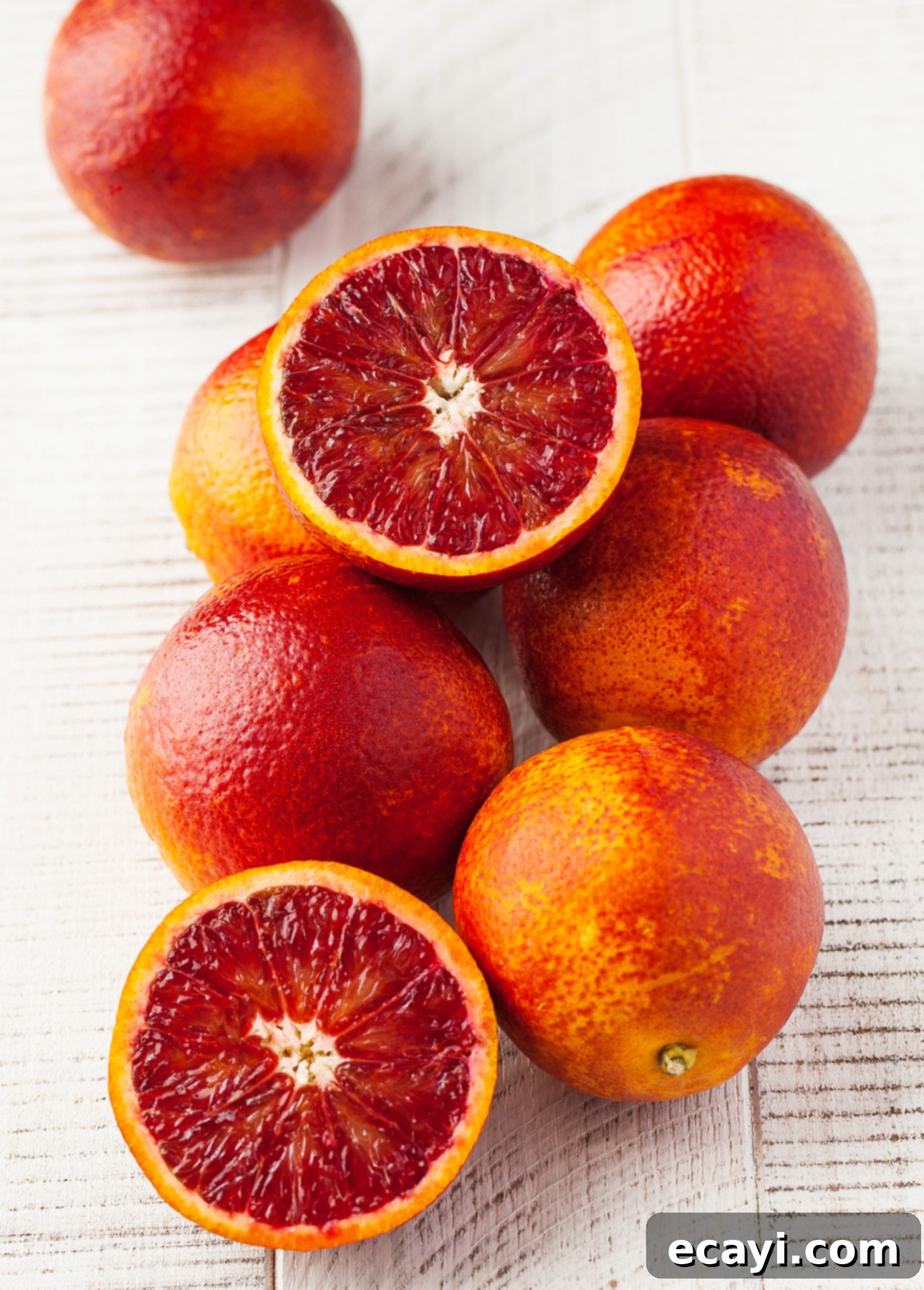 Decadent Blood Orange Chocolate Lava Cakes 6 A vibrant collection of ripe blood oranges, some whole and some halved, displayed against a light background.