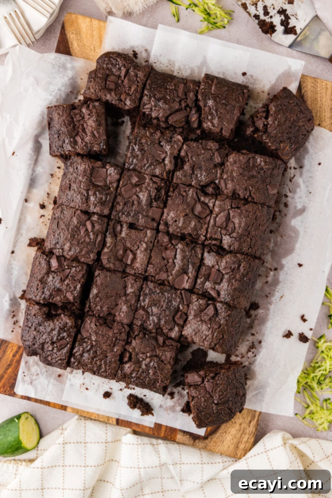 Hidden Veggie Fudge 2 Zucchini Brownies cut into squares on parchment paper, showcasing their fudgy texture