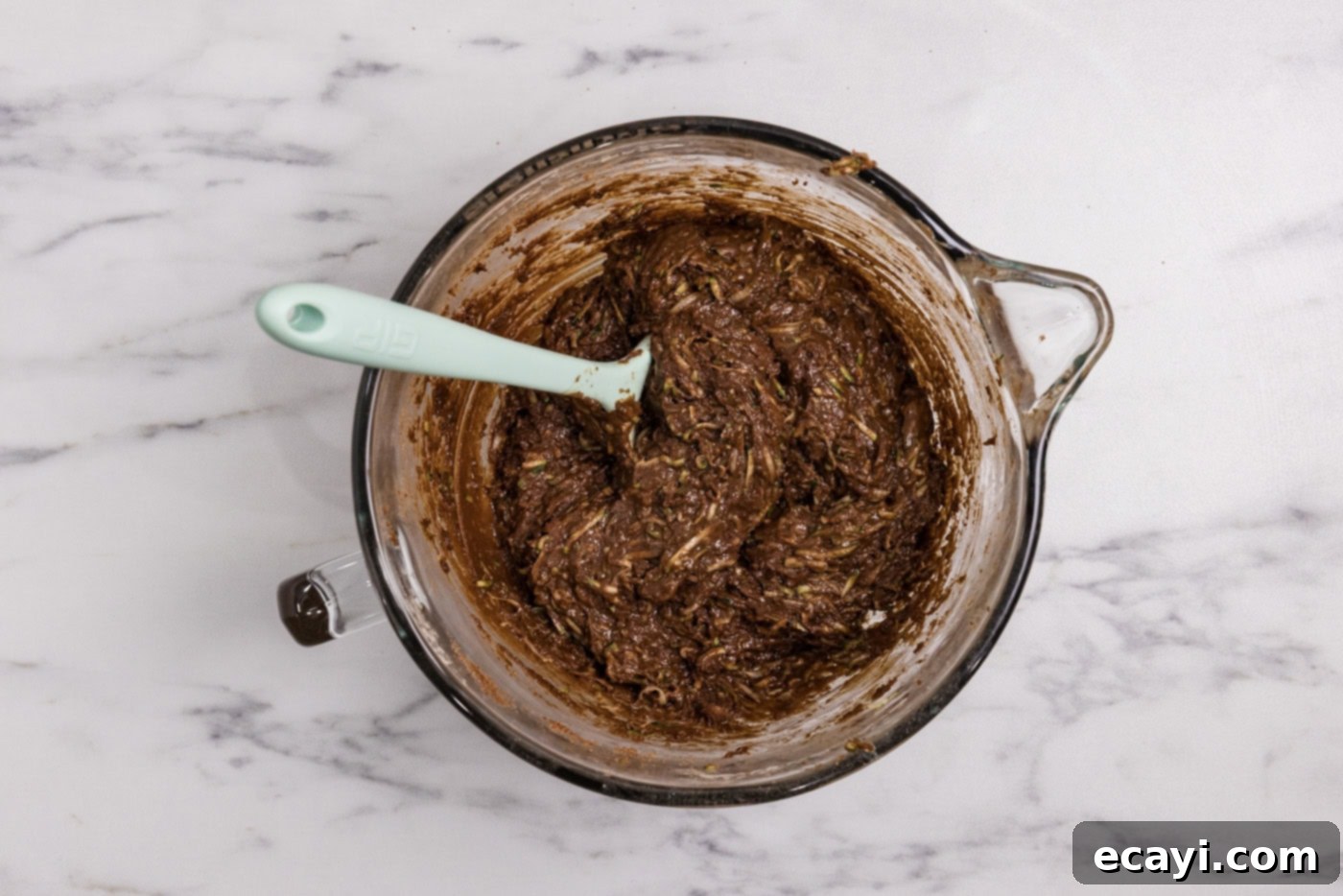 Hidden Veggie Fudge 9 Rubber spatula in a bowl with zucchini brownie batter after resting, now moistened