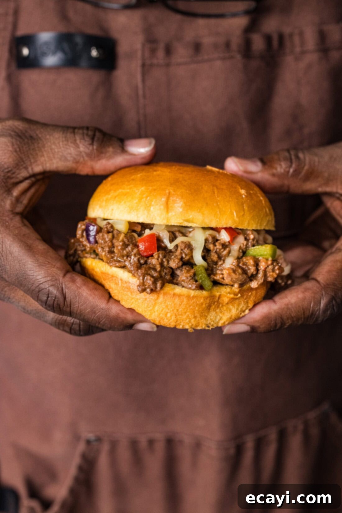 Philly Cheesesteak Messy Melts 3 Hands holding a messy Philly Cheesesteak Sloppy Joe sandwich