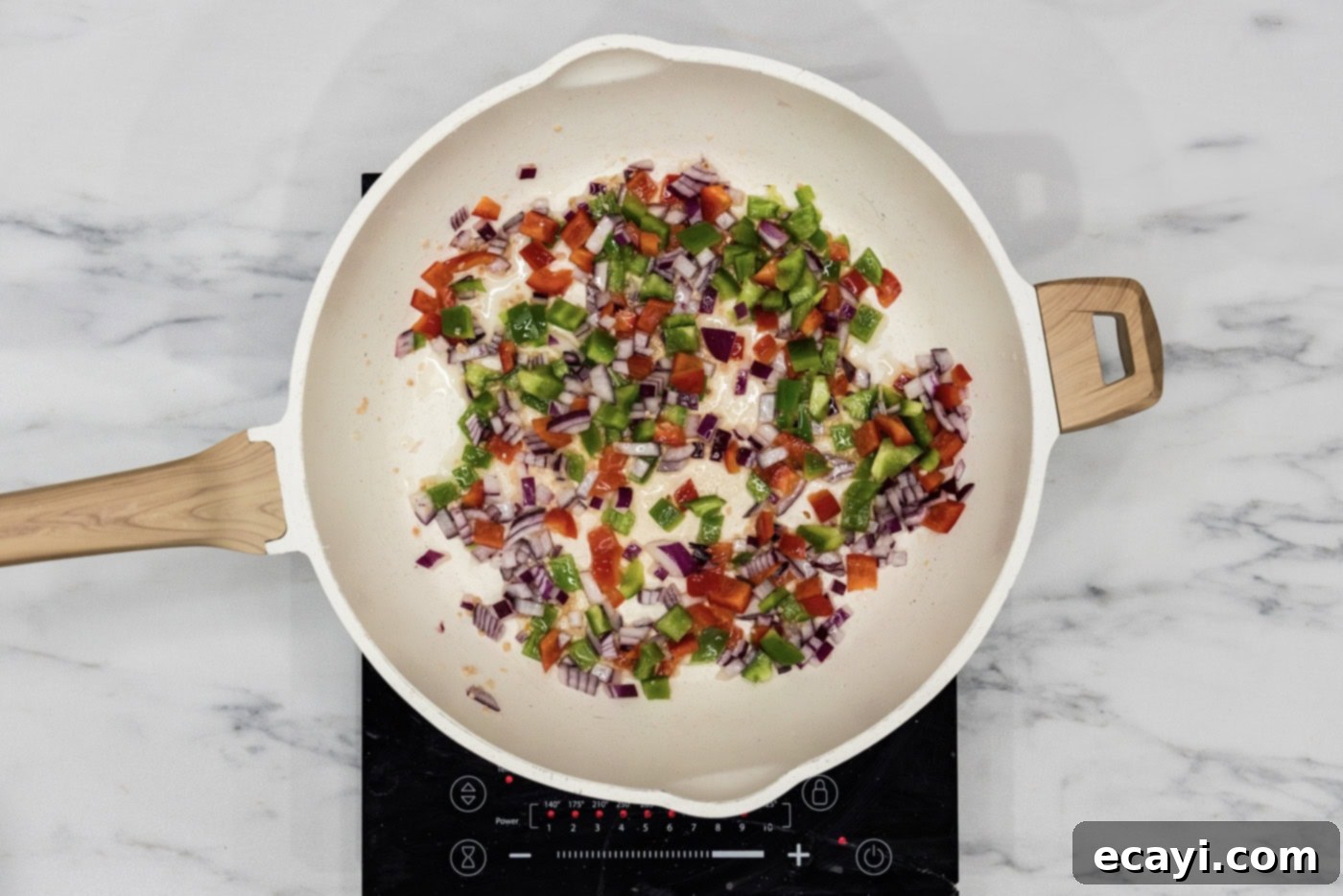 Philly Cheesesteak Messy Melts 5 Bell peppers, onion, and minced garlic sautéing in a hot skillet