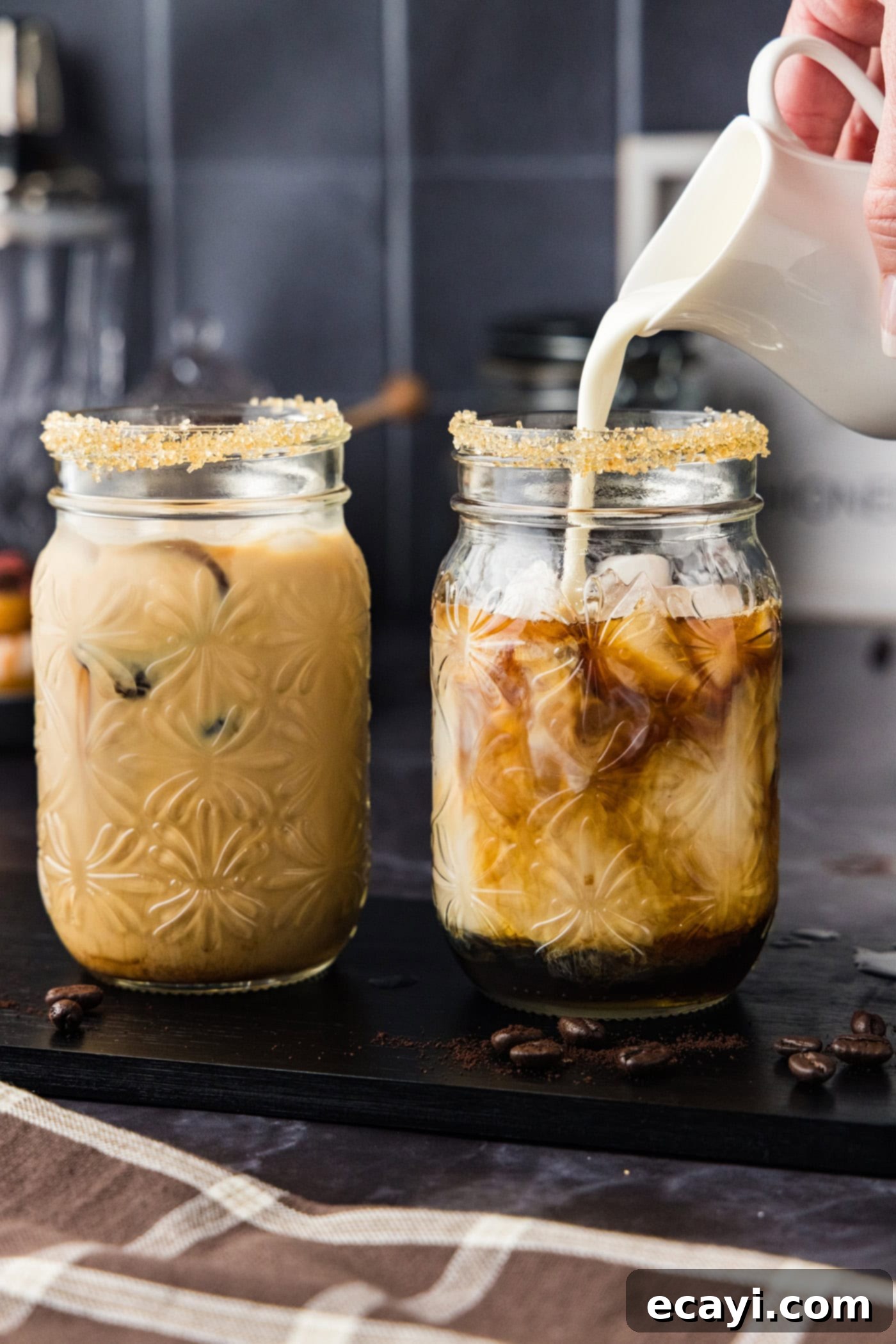 Velvet Espresso Chill 8 Thick heavy cream being poured gently over the top of the iced espresso cocktail, creating a luscious, creamy layer.