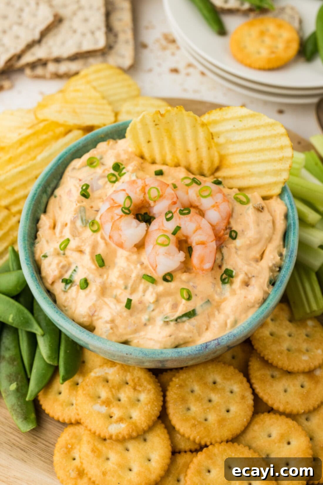 Creamy Shrimp Delight 2 Close up photo of a bowl of Shrimp Dip with two chips in it, showcasing its creamy texture