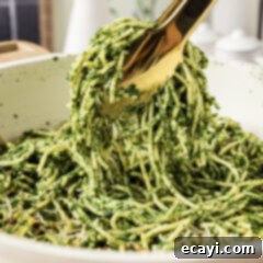 Vibrant Spinach Spaghetti 12 Close up photo of tongs holding up Spinach Spaghetti
