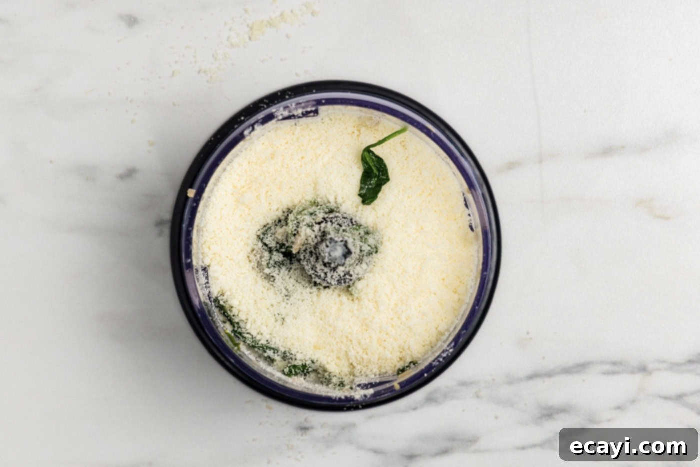 Vibrant Spinach Spaghetti 8 Parmesan cheese added to the spinach mixture in a food chopper.