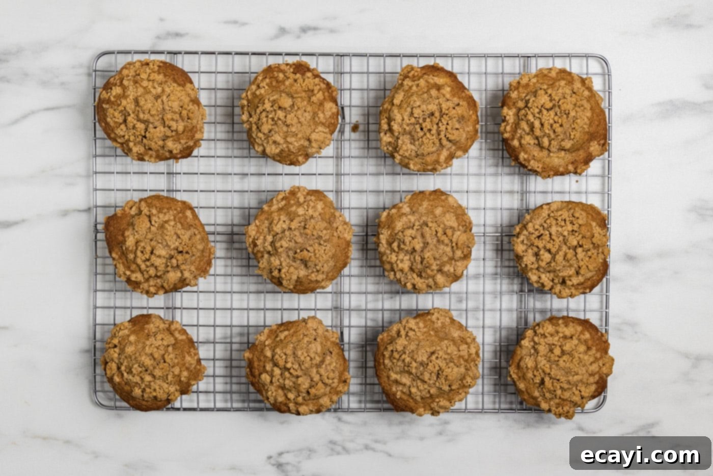 Spiced Apple Muffins 12 baked apple streusel muffins on a wire cooling rack