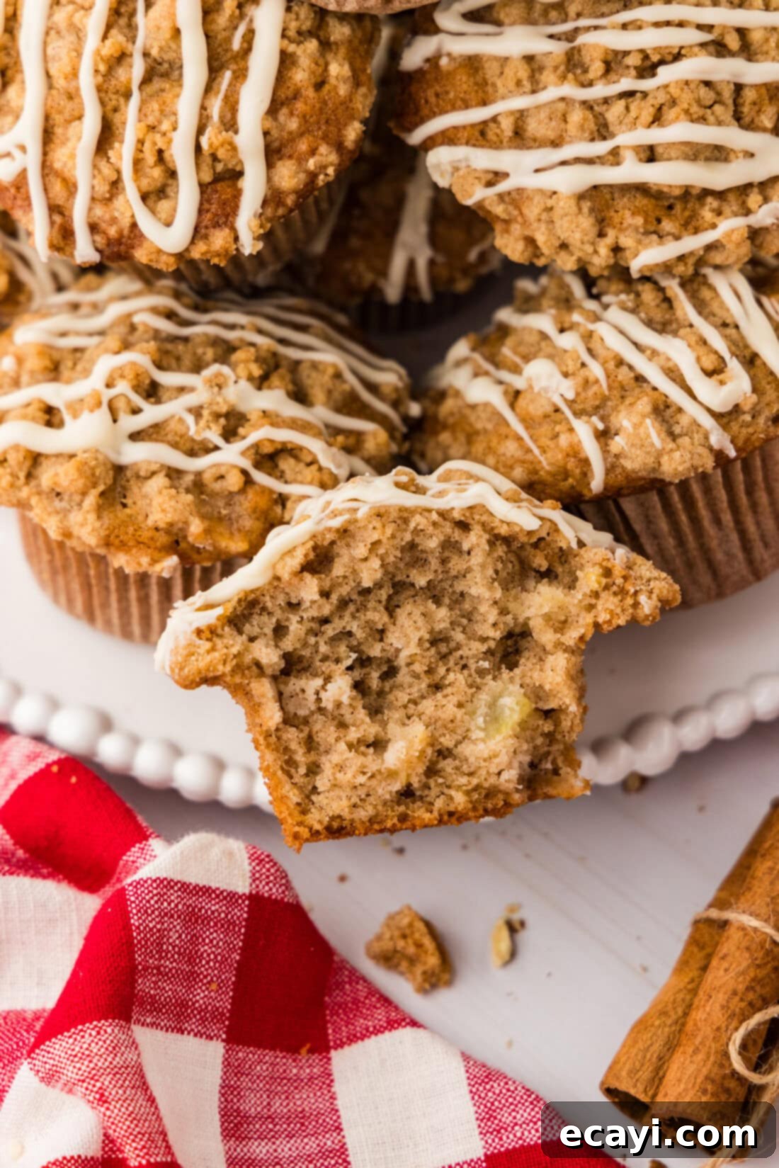 Spiced Apple Muffins 3 Close up photo of half of a Apple Muffin with more muffins behind it
