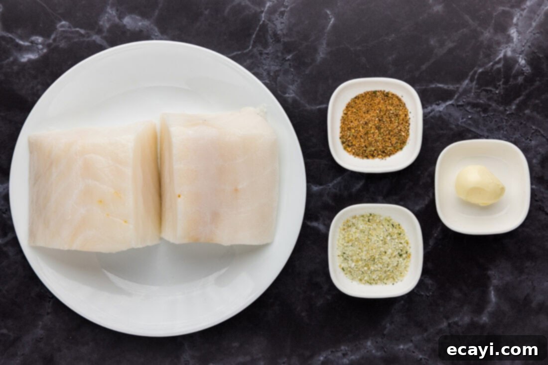 Buttery Grilled Chilean Sea Bass 4 Four simple ingredients for grilled Chilean sea bass: raw fish fillets, melted butter, Old Bay seasoning, and garlic salt.