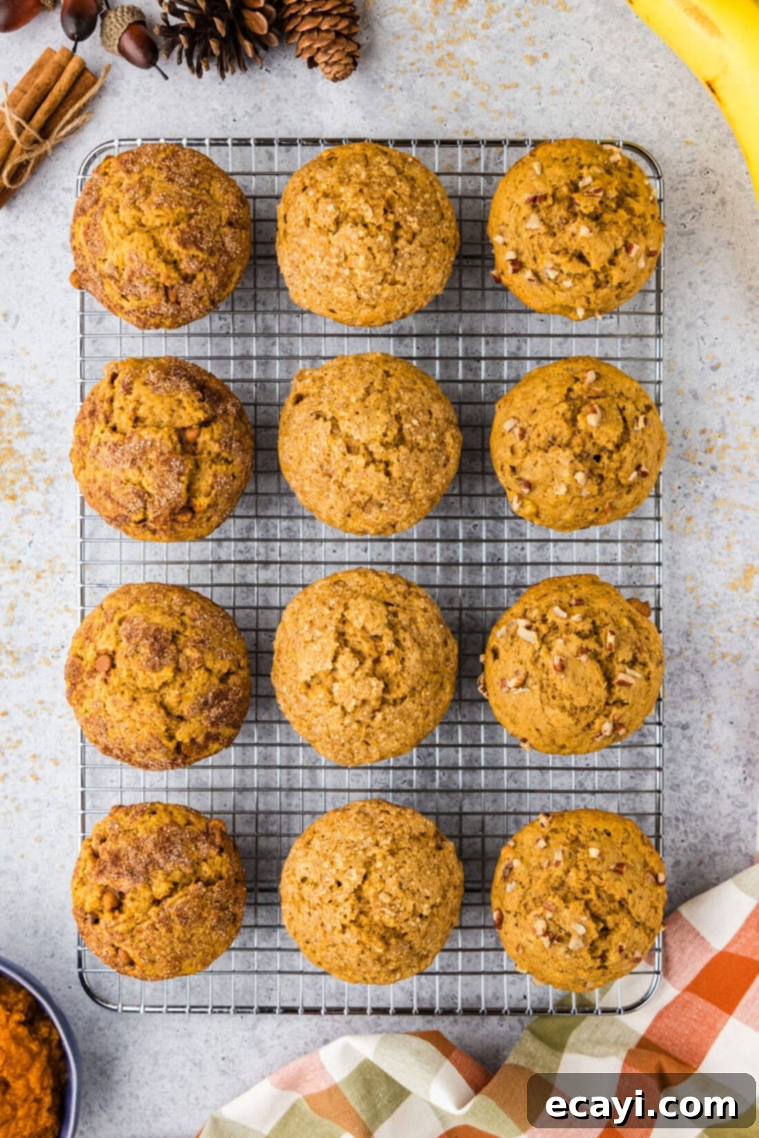 Golden Harvest Pumpkin Banana Muffins 3 Warm Pumpkin Banana Muffins resting on a wire rack, ready to be enjoyed