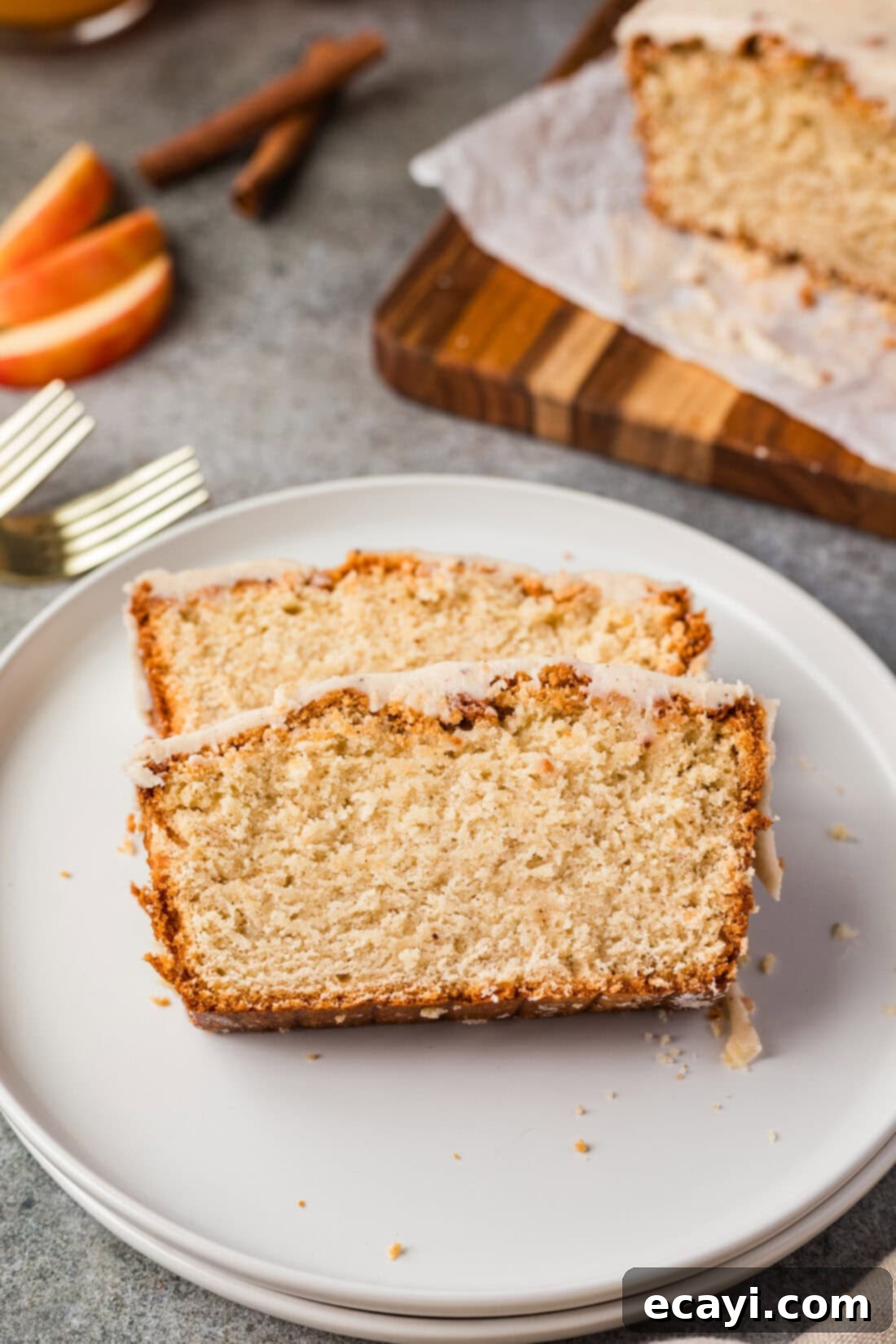Spiced Apple Cider Pound Cake 3 Two generous slices of Apple Cider Pound Cake presented on a rustic plate, ready to be enjoyed.