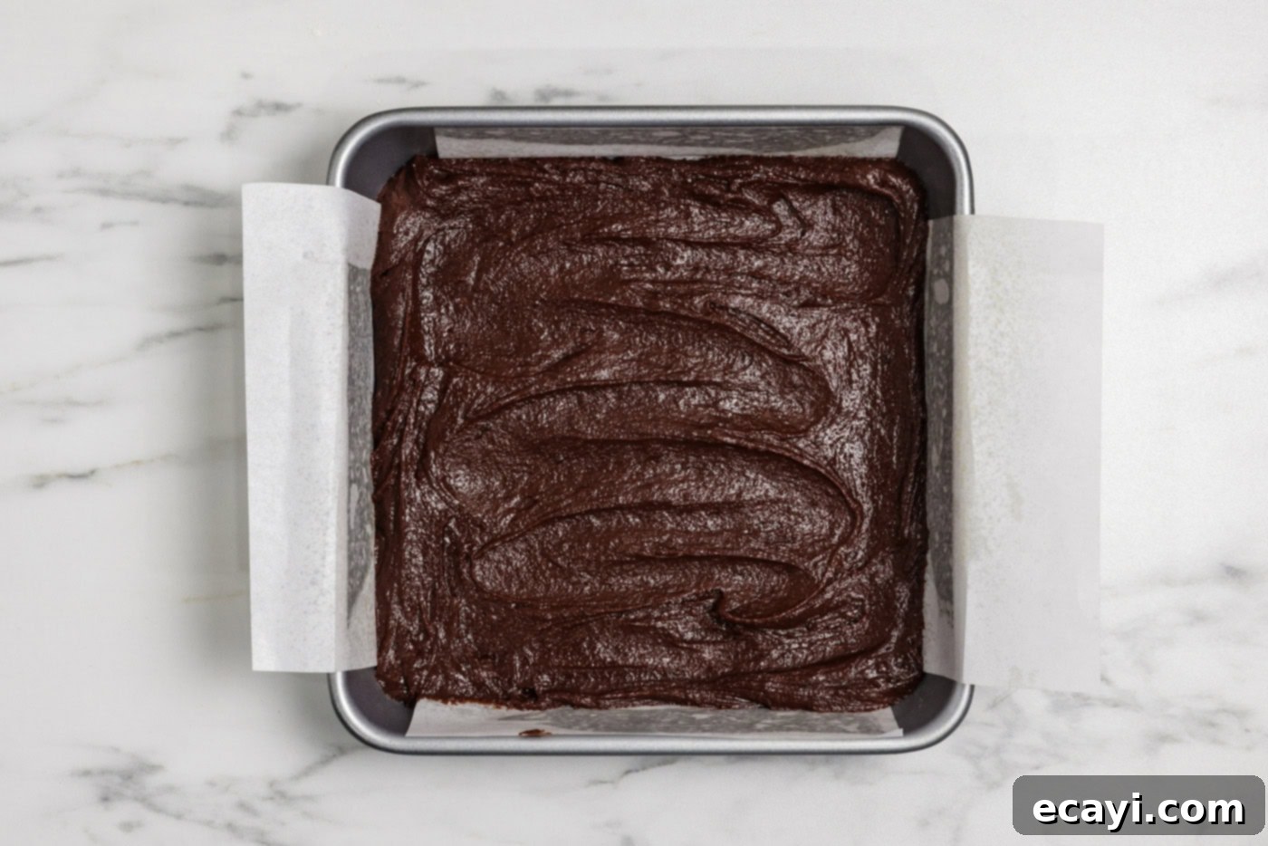 Spiced Pumpkin Cheesecake Swirl Brownies 11 brownie batter spread in a 9x9 baking pan