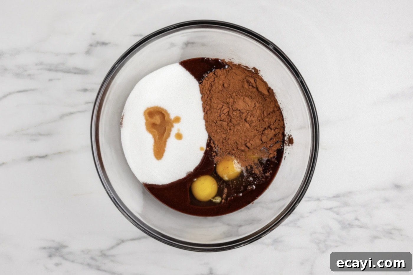 Spiced Pumpkin Cheesecake Swirl Brownies 8 eggs, cocoa, sugar, and vanilla added to melted chocolate in a bowl