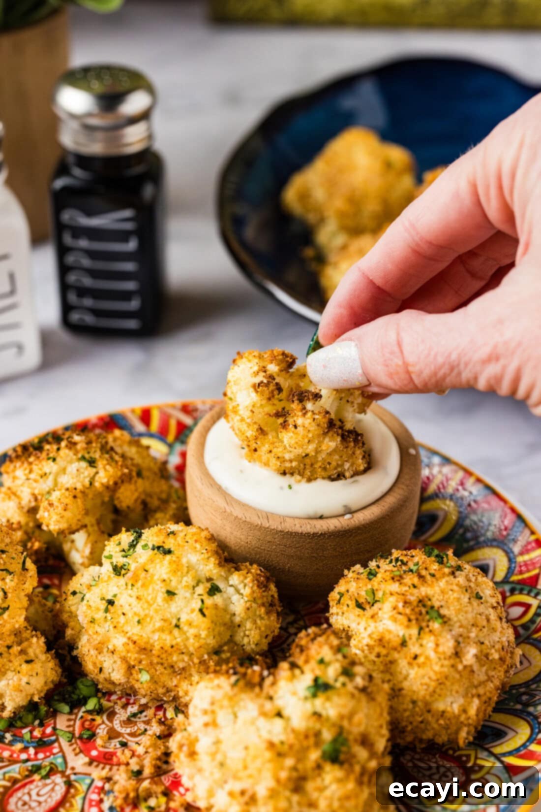 Crispy Air Fried Cauliflower 3 Air Fryer Fried Cauliflower being dipped in ranch